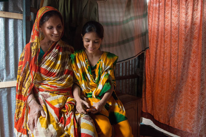 A BRAC Microfinance client and her daughter using bKash – Photo credit: Minhaz Ali