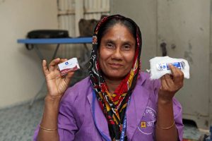 Fatema Akter, a BRAC community health promoter in Dhaka, holding the contents of a delivery kit