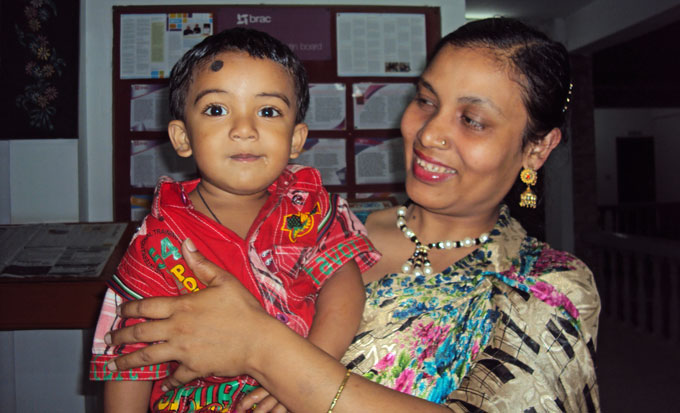 Frontline community health worker Asma Akhter with her second child Arafat