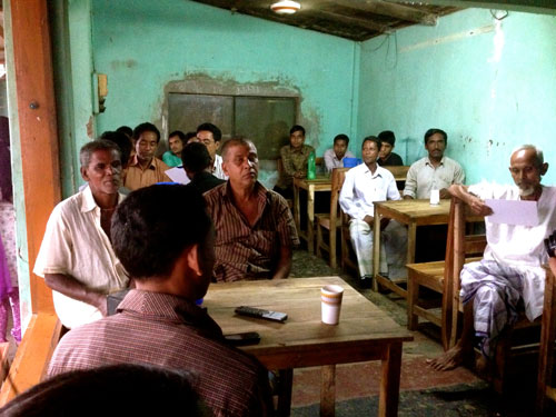 While taking a short break from work in the afternoon, men attend a BRAC WASH tea stall meeting.