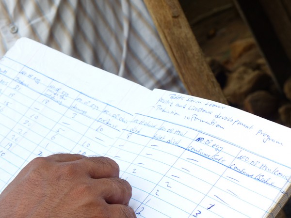 Reviewing a poultry accounting logbook with BRAC clients in Sierra Leone. (Photo: BRAC/Rod Dubitsky)